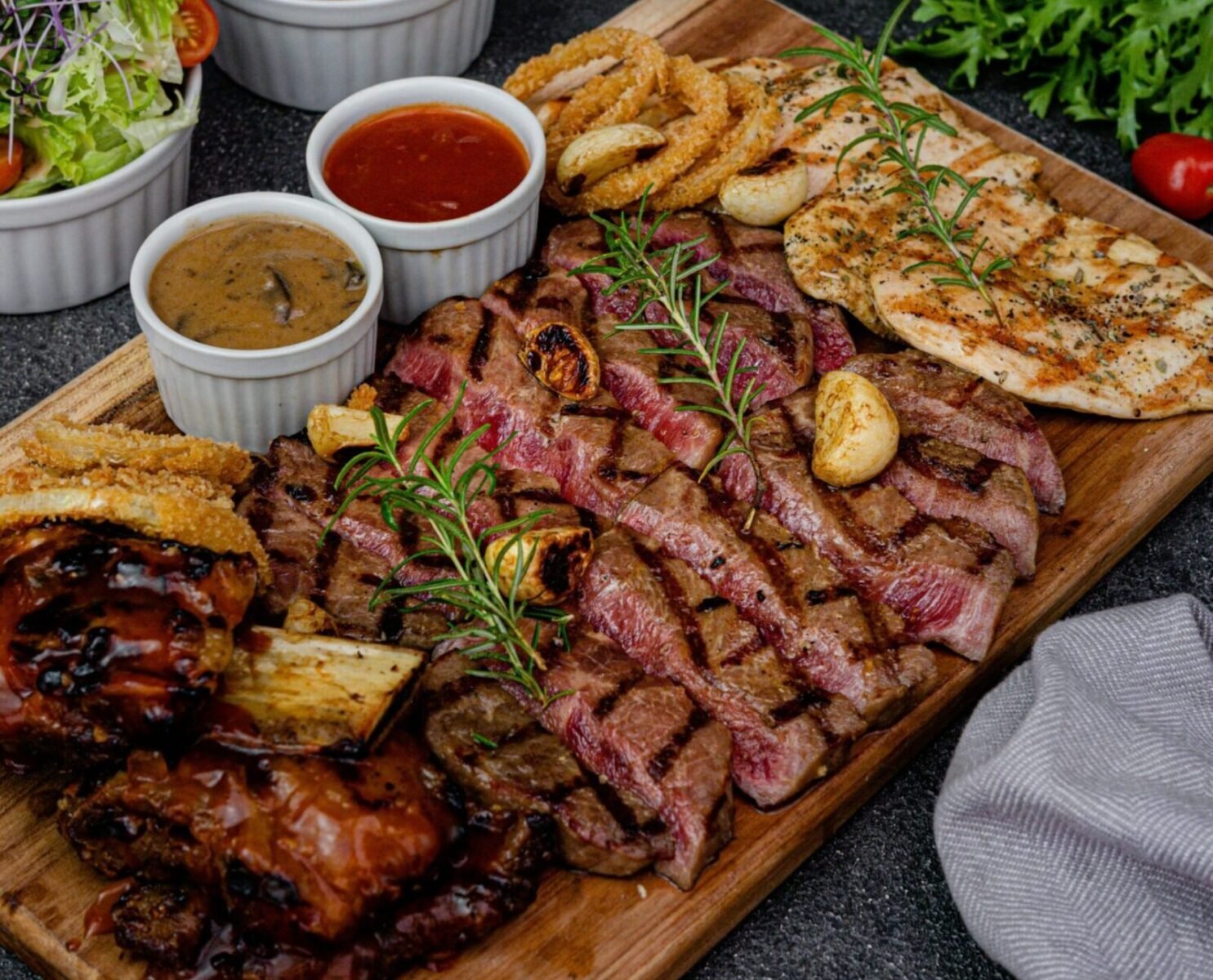 Savor this delectable meat selection with sauces and crispy wedges.